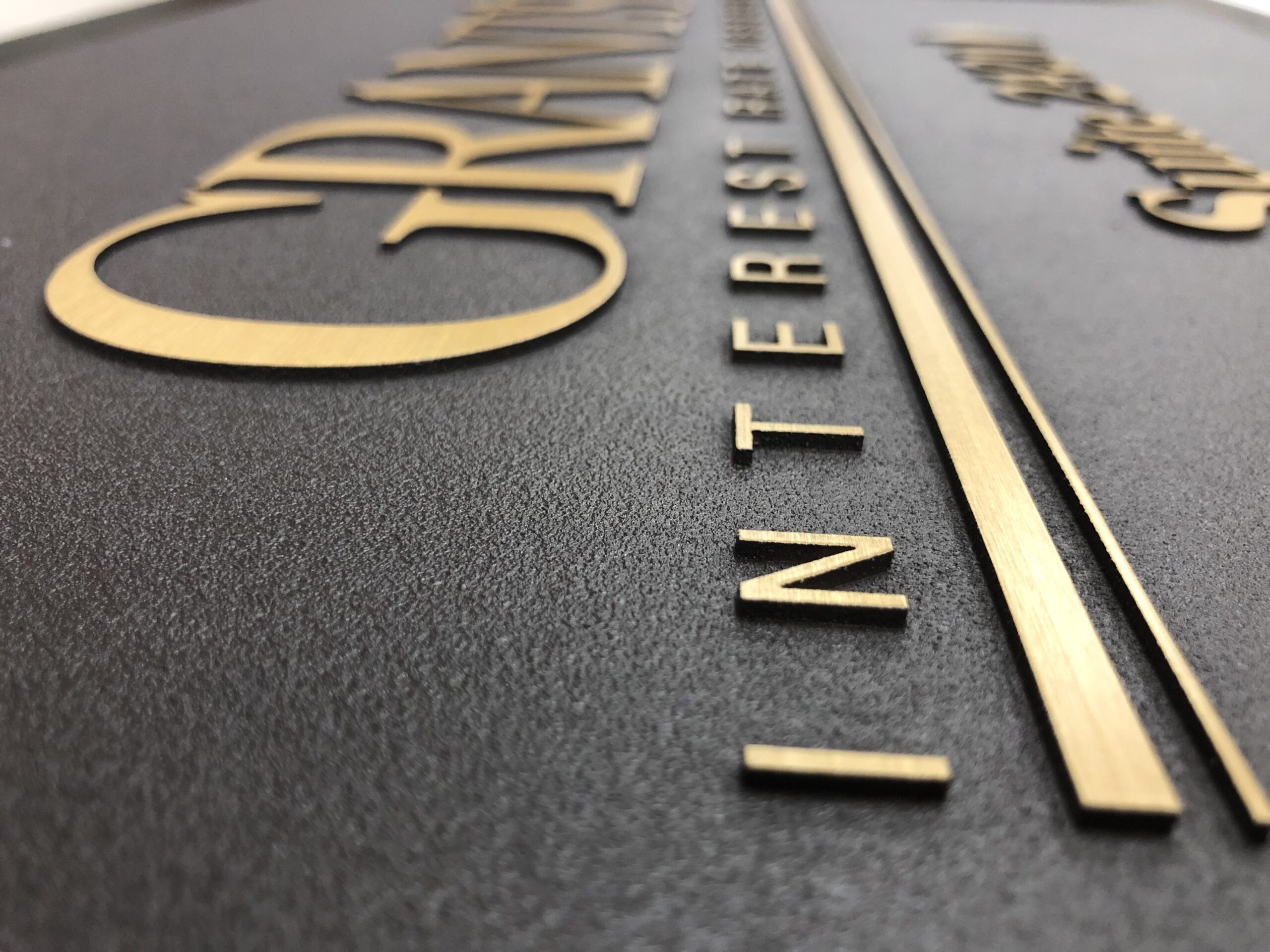 Raised brass letters with brushed finishing
