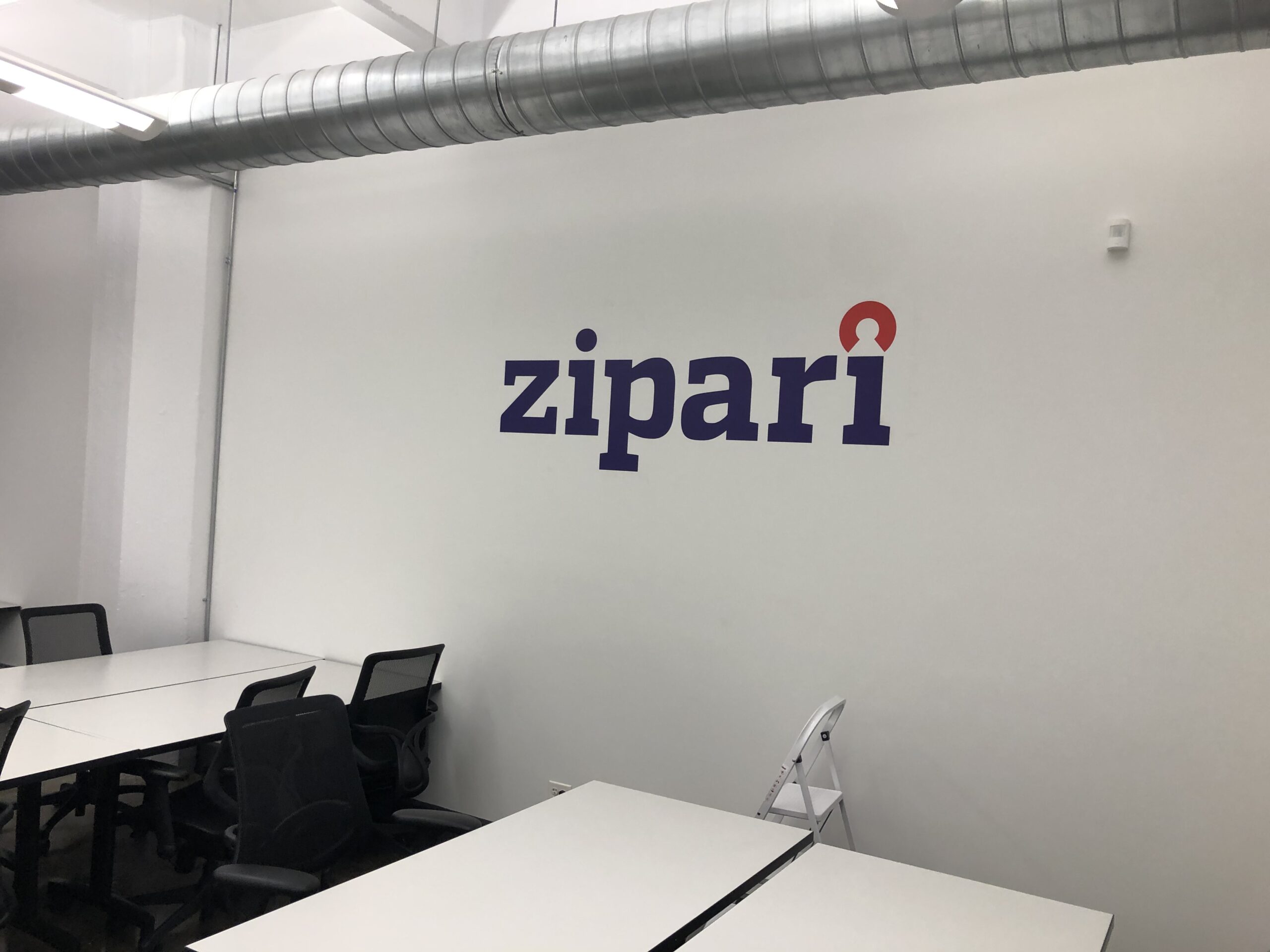 A custom wall decal with ZIPARI logo for office lobby